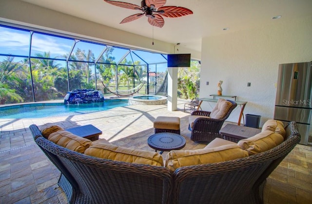 view of patio / terrace with pool water feature, a lanai, ceiling fan, a pool with hot tub, and an outdoor living space