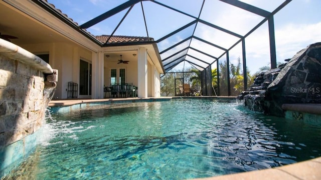 view of swimming pool with a patio, pool water feature, ceiling fan, and a lanai