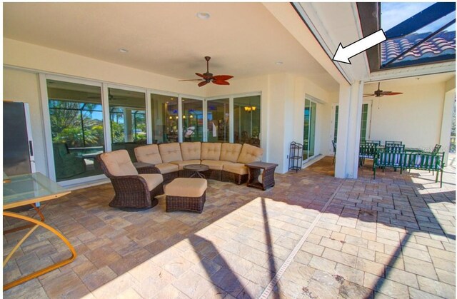 view of patio with outdoor lounge area and ceiling fan