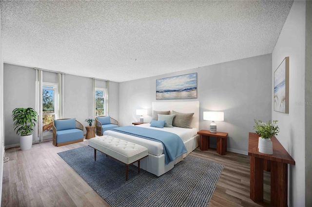 bedroom with hardwood / wood-style floors and a textured ceiling