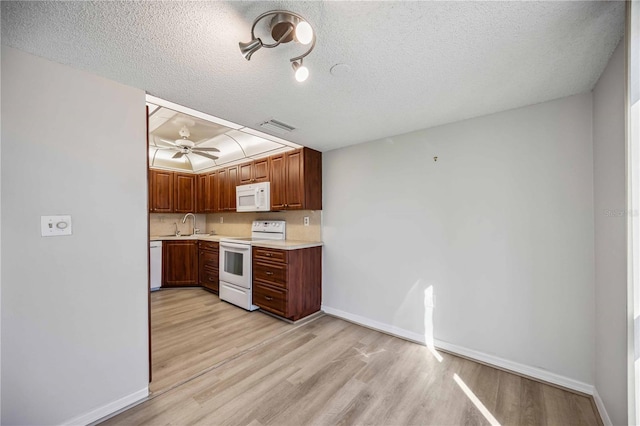 kitchen with tasteful backsplash, a textured ceiling, light wood-type flooring, ceiling fan, and white appliances