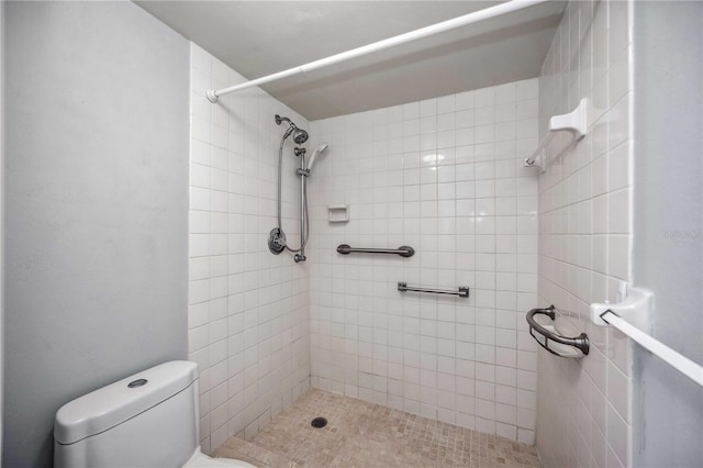 bathroom with tiled shower and toilet