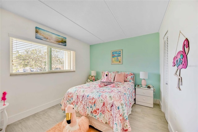 bedroom featuring light hardwood / wood-style flooring and a closet