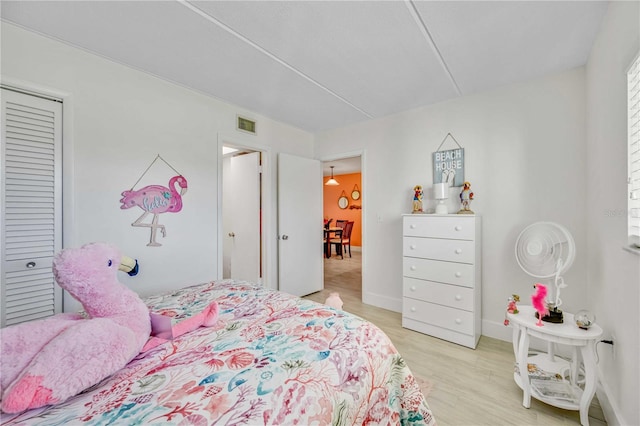 bedroom featuring a closet and light wood-type flooring