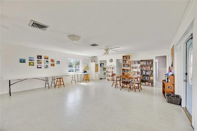 dining area with a textured ceiling and ceiling fan