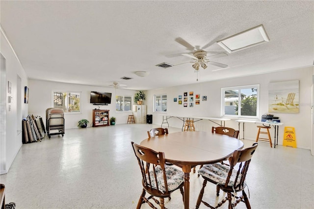 dining space with ceiling fan and a healthy amount of sunlight