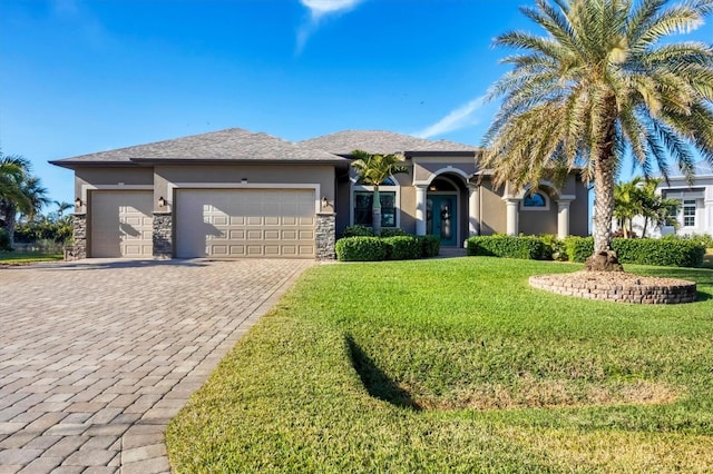 view of front of home with a garage and a front lawn