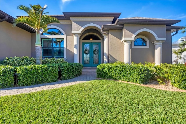 exterior space featuring french doors and a lawn