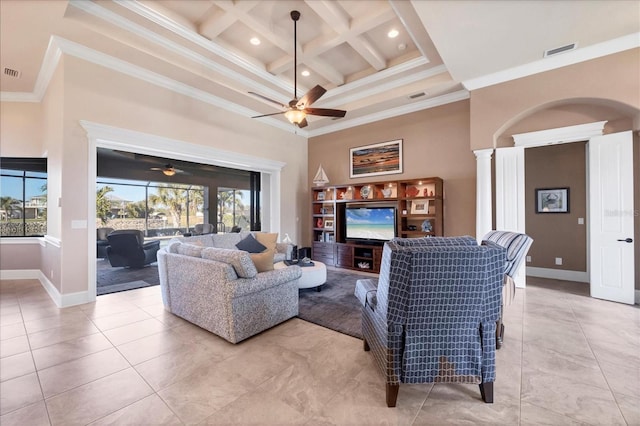 tiled living room featuring ceiling fan, a towering ceiling, coffered ceiling, ornamental molding, and beamed ceiling