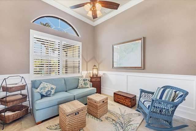 living room featuring crown molding, ceiling fan, and plenty of natural light