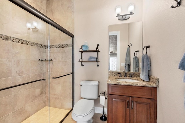 bathroom with vanity, walk in shower, and toilet