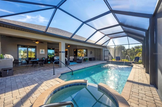 view of pool featuring pool water feature, a lanai, and a patio