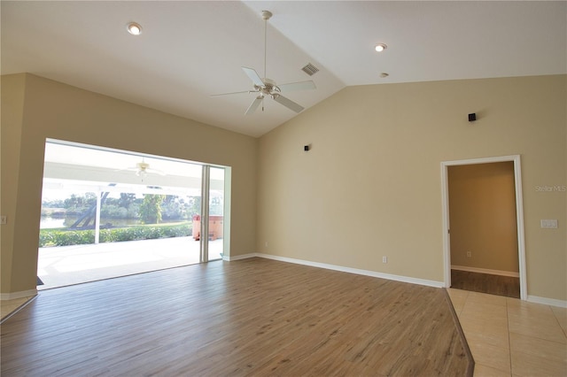 unfurnished room with hardwood / wood-style flooring, high vaulted ceiling, and ceiling fan