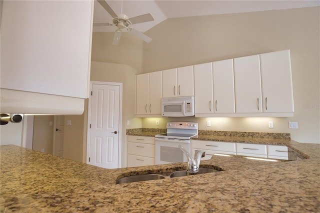 kitchen with white appliances, sink, and white cabinets