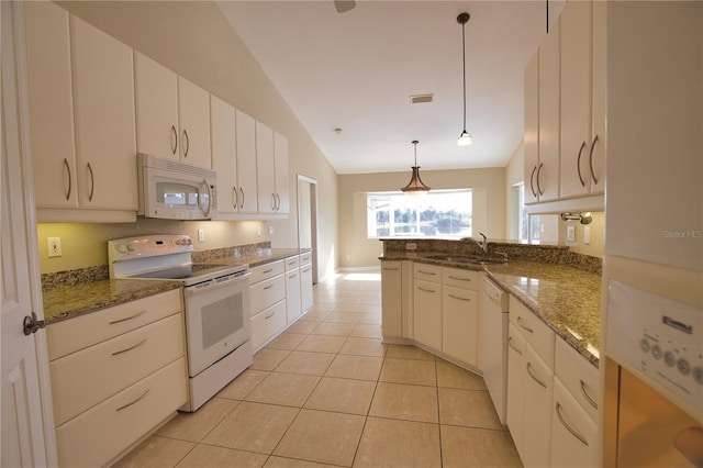 kitchen featuring pendant lighting, white appliances, dark stone counters, and sink