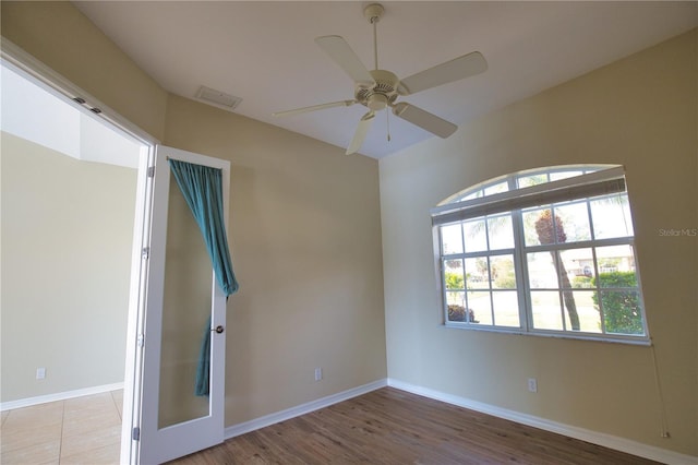 spare room with hardwood / wood-style floors and ceiling fan