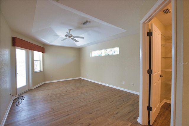 spare room with hardwood / wood-style flooring, plenty of natural light, and ceiling fan