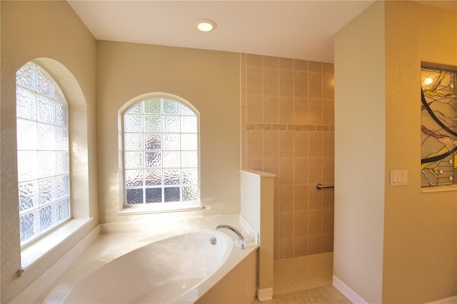 bathroom with shower with separate bathtub