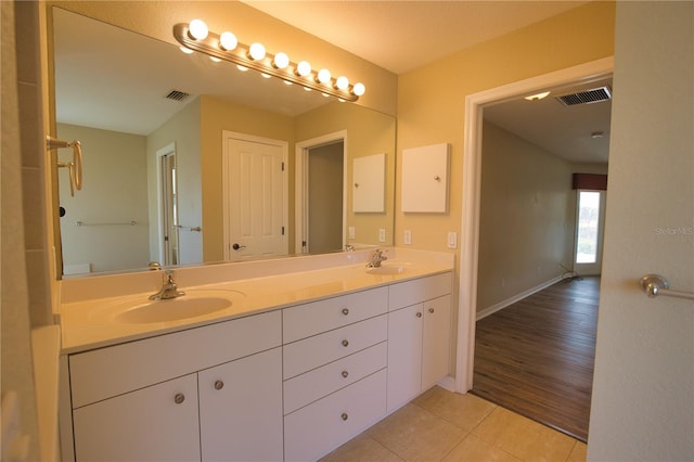 bathroom featuring tile patterned flooring and vanity