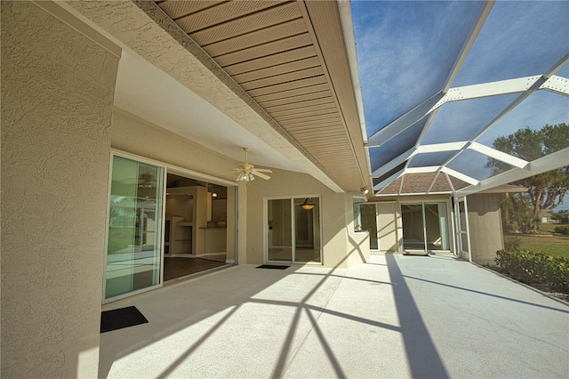 view of patio featuring a lanai and ceiling fan