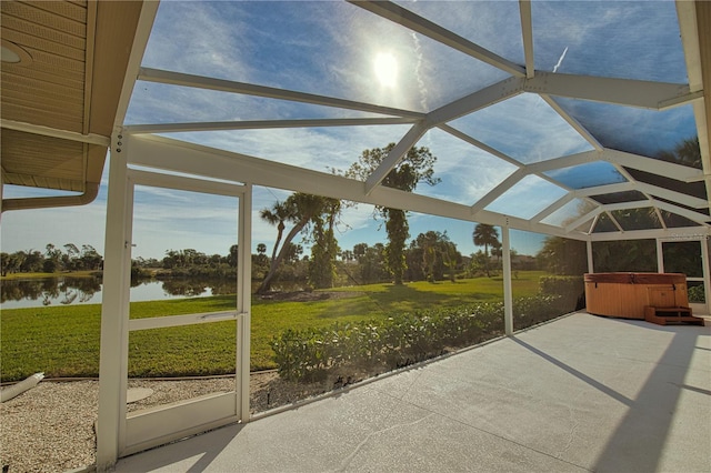 unfurnished sunroom featuring a water view and lofted ceiling