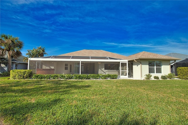 rear view of property featuring a yard