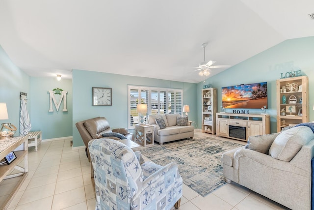 living room featuring lofted ceiling, light tile patterned floors, and ceiling fan