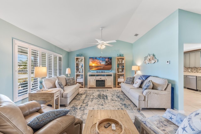 living room featuring lofted ceiling, a fireplace, ceiling fan, and light tile patterned flooring