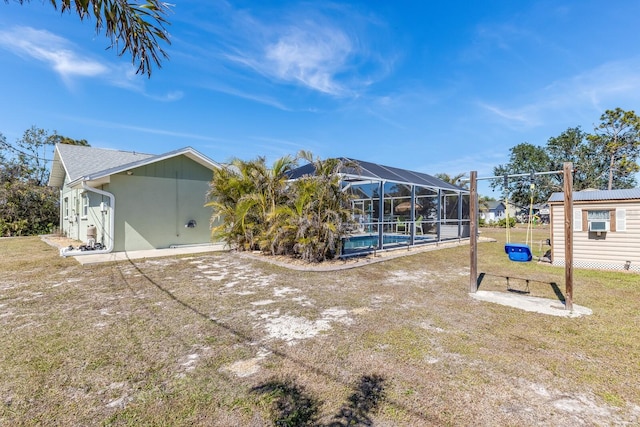 view of yard with glass enclosure