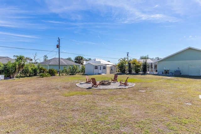 view of yard with a fire pit