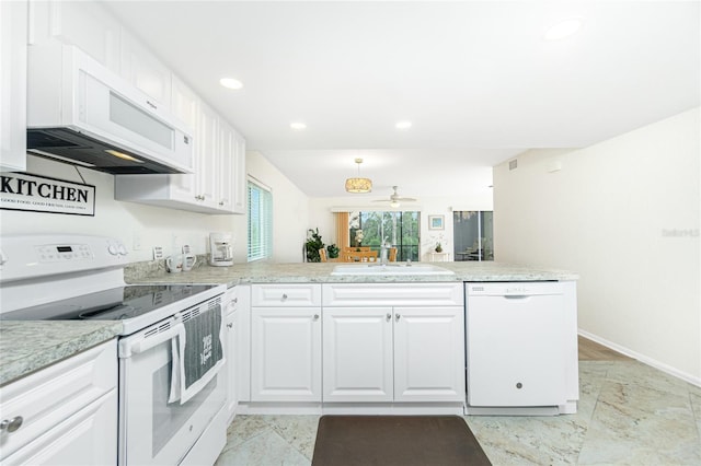 kitchen with white appliances, kitchen peninsula, sink, and white cabinets