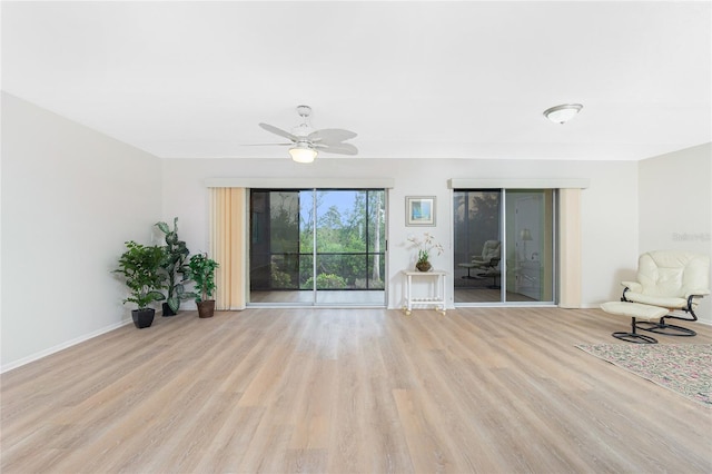 unfurnished living room featuring ceiling fan and light hardwood / wood-style flooring