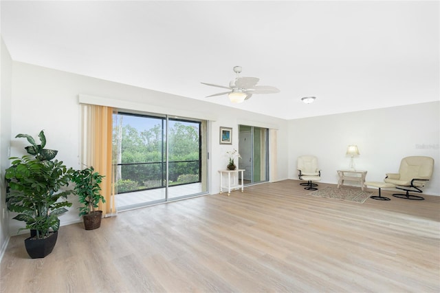 living area with ceiling fan and light wood-type flooring