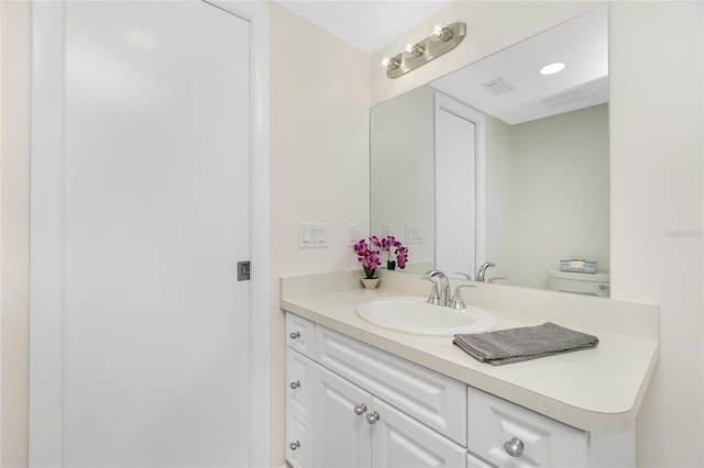 bathroom featuring vanity and toilet