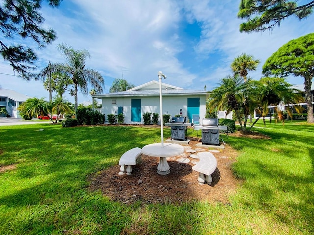 rear view of house featuring a yard