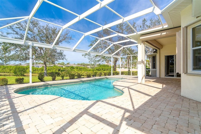 outdoor pool with a lanai and a patio area