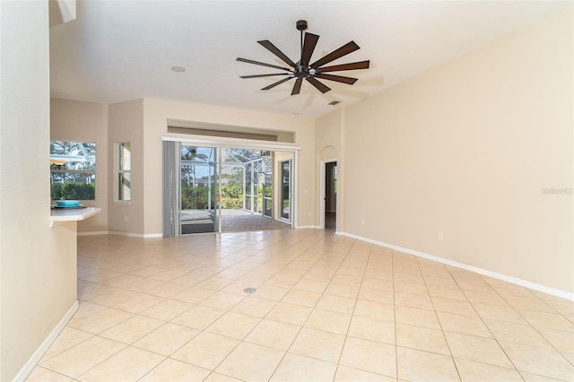 tiled spare room featuring ceiling fan