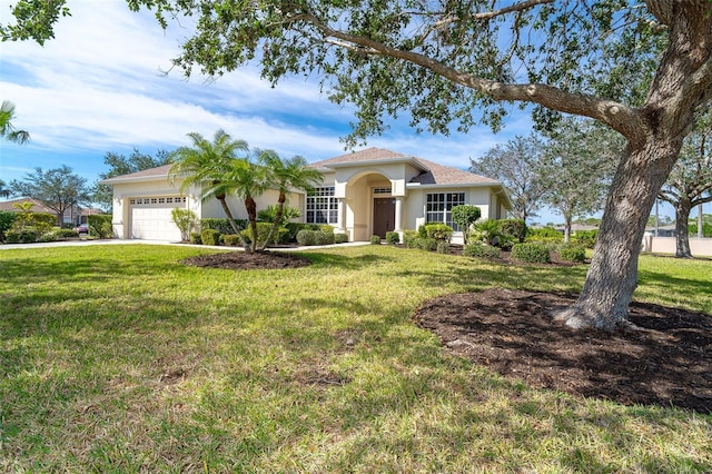 view of front of property with a front yard, an attached garage, driveway, and stucco siding