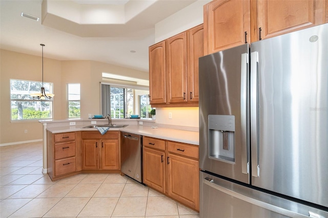 kitchen featuring a sink, stainless steel appliances, light tile patterned floors, and light countertops