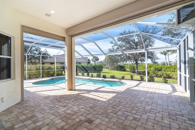 view of swimming pool with a patio and glass enclosure