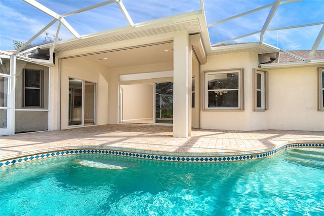 outdoor pool featuring a patio area and glass enclosure