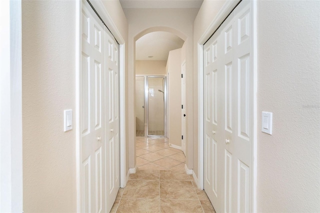 hall featuring light tile patterned floors