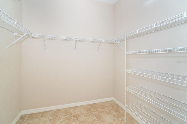 spacious closet with light tile patterned floors