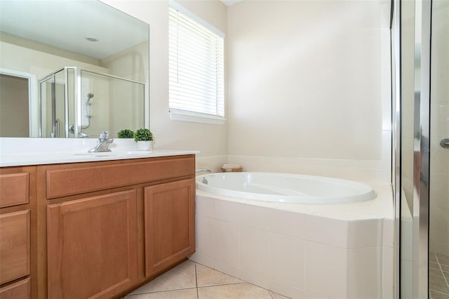 bathroom featuring vanity, a shower stall, a bath, and tile patterned floors