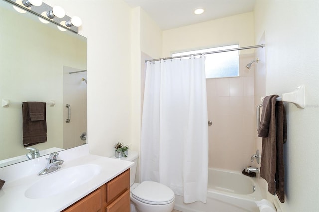 bathroom featuring shower / bathtub combination with curtain, toilet, and vanity