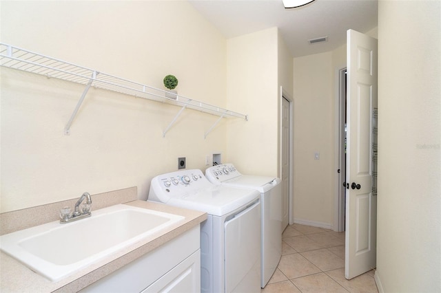 washroom featuring light tile patterned floors, visible vents, laundry area, separate washer and dryer, and a sink