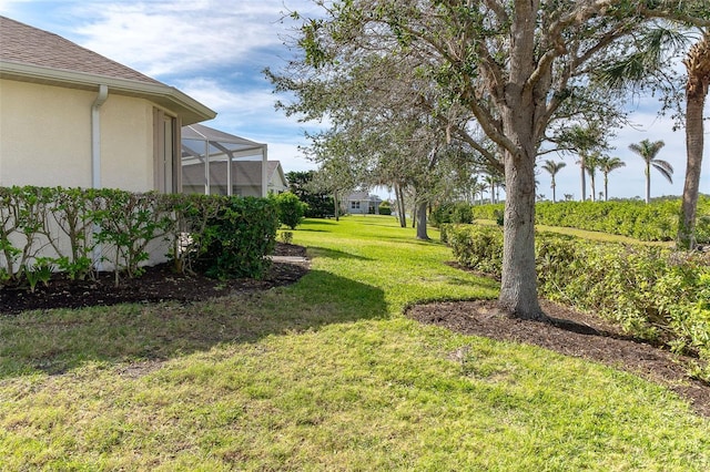 view of yard with a lanai