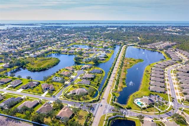 drone / aerial view featuring a residential view and a water view