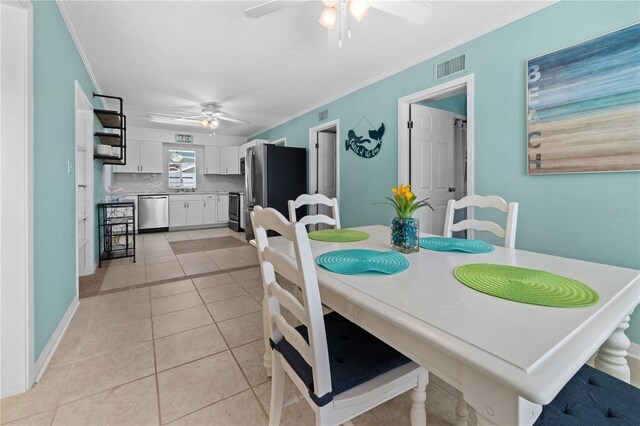 539 Shore Rd, Nokomis, FL 34275 - dining space with ceiling fan, ornamental molding, and light tile patterned flooring