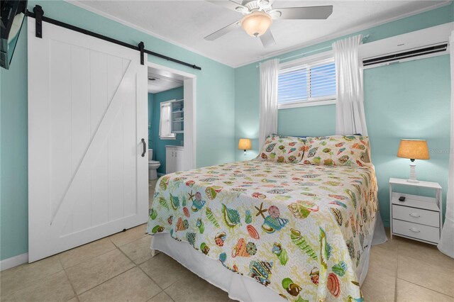 539 Shore Rd, Nokomis, FL 34275 - tiled bedroom with a barn door, ceiling fan, ensuite bathroom, and an AC wall unit